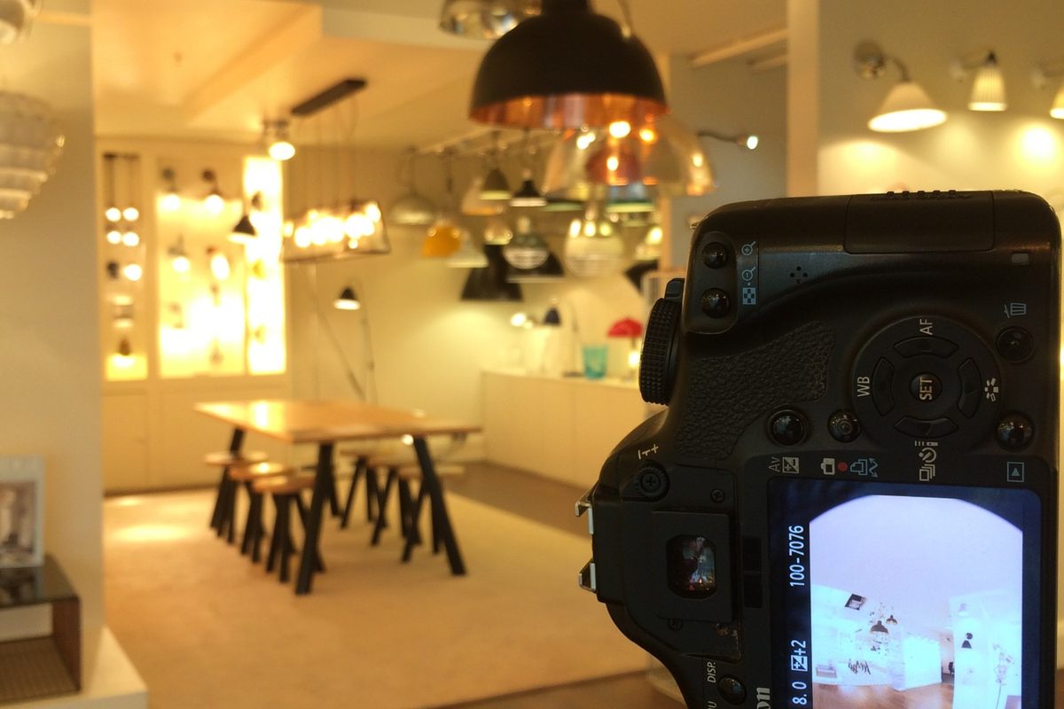 A fisheye frame on the camera screen in a lighting showroom